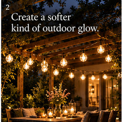 Aurelia Solar Drop Lights creating a warm glow beneath a pergola dining space