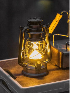 Close-up of the black Haven lantern with a warm glowing light source
