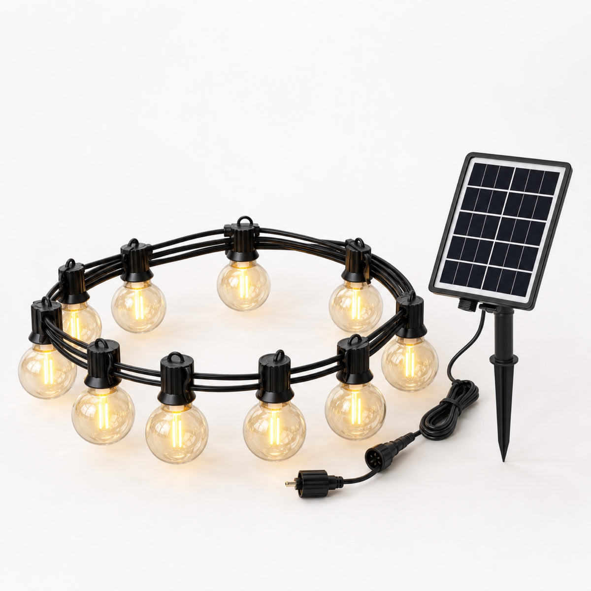 Heritage Solar Bistro Lights — clear globe bistro bulbs on a black cable with a separate solar panel over a patio