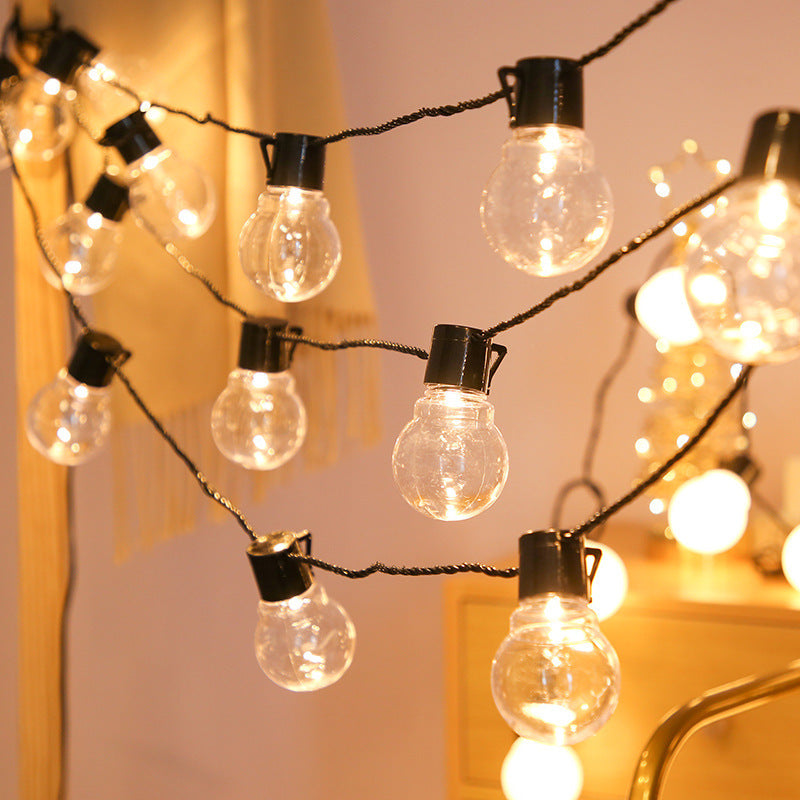 Warm clear globe string lights with black sockets; collection inspiration
