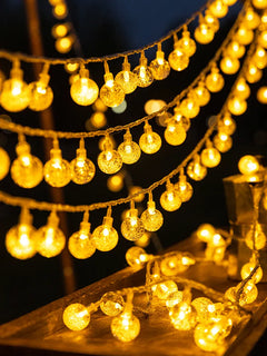 Close-up of Celeste clear globe string lights glowing warm white