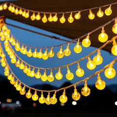 Celeste warm globe string lights arranged overhead at dusk