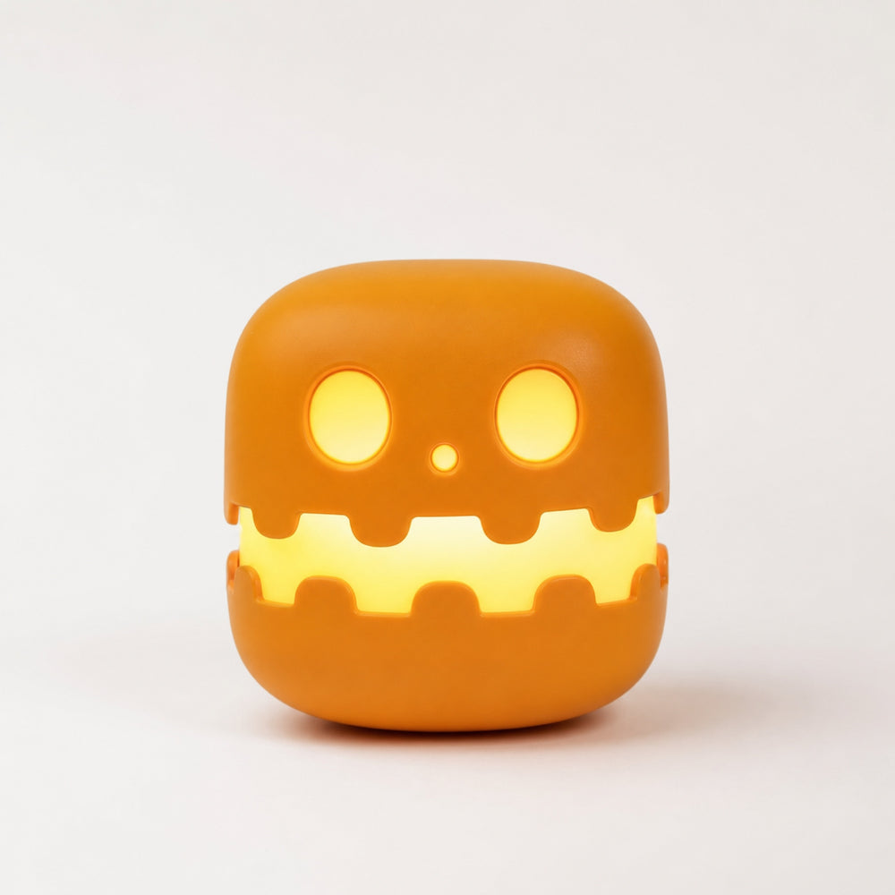 Ember LED Pumpkin Night Light — small pumpkin-shaped accent light glowing warm orange on a shelf