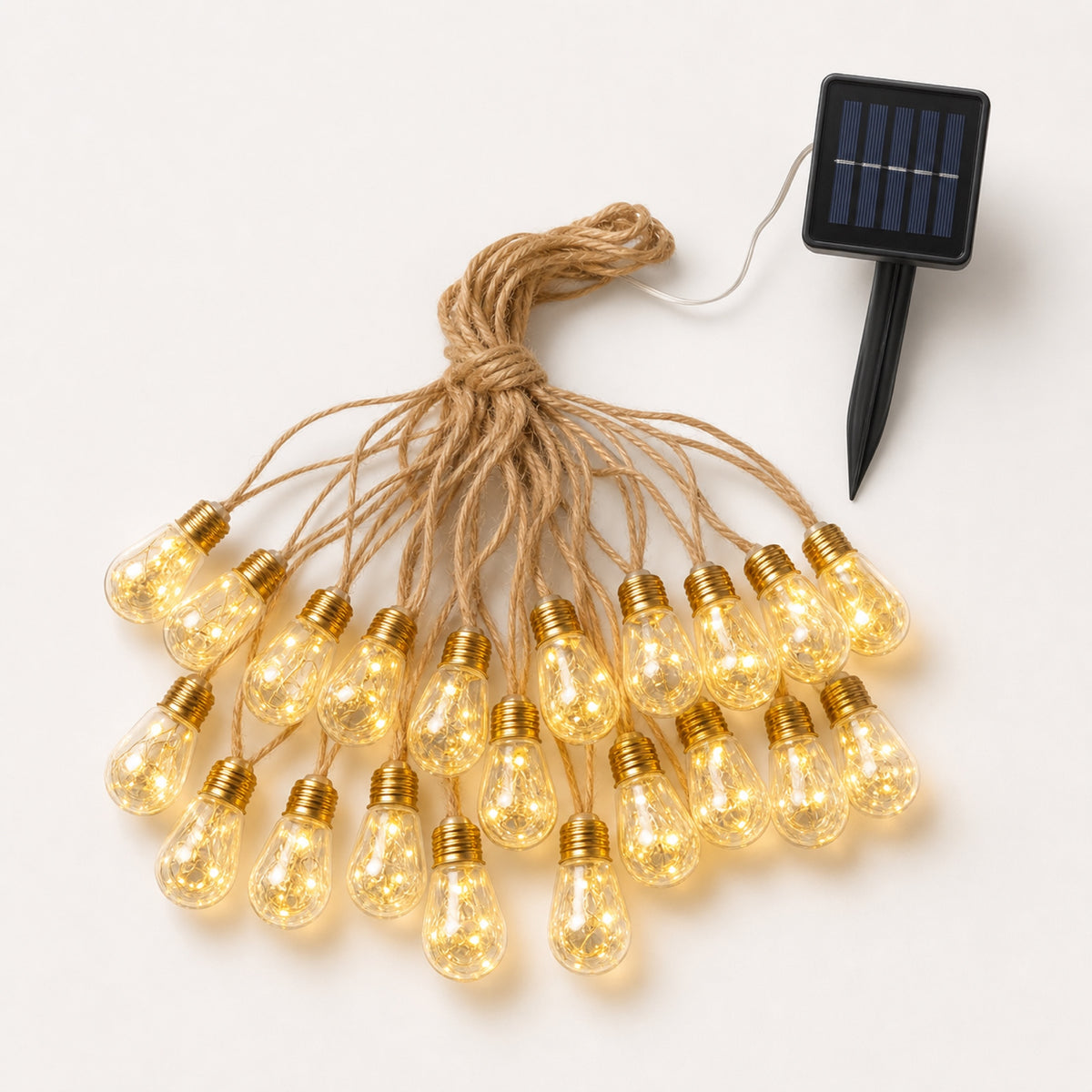 Hearthdrop Rope String Lights — warm drop-shaped patio string lights on a natural-look rope cable over an outdoor dining table