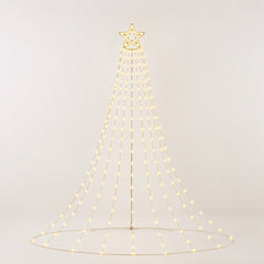 Starlace Curtain Lights — tree-shaped warm light display with a star topper and cascading strands in a living room